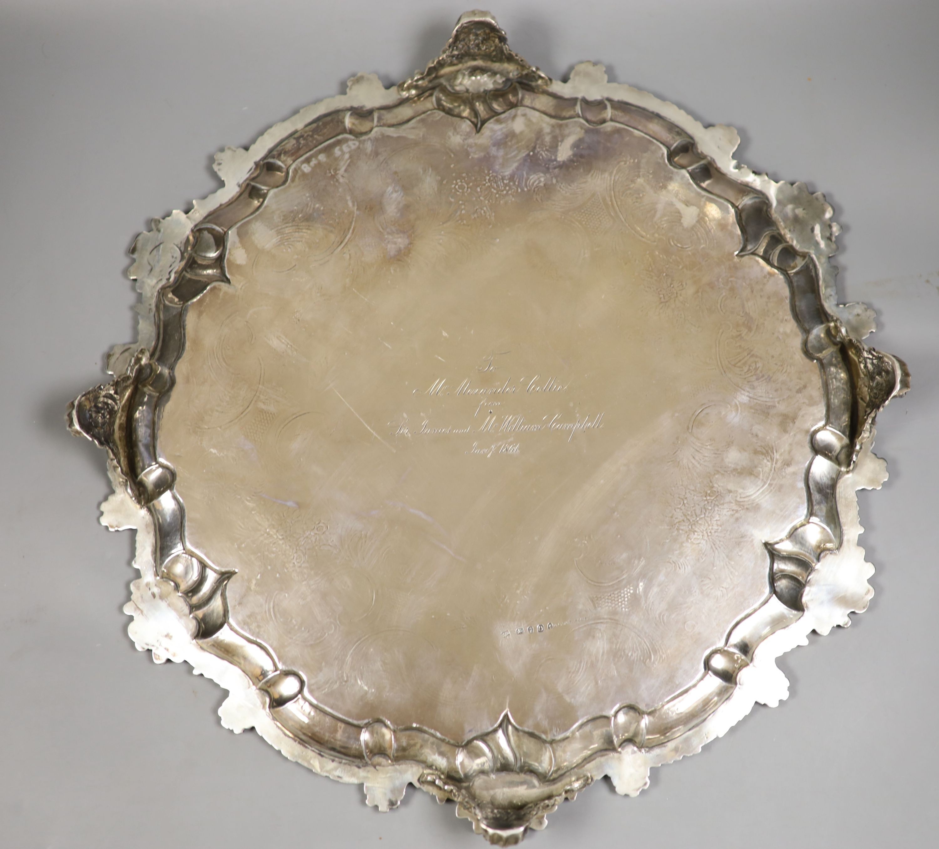 WITHDRAWN A George III large engraved silver salver, by Peter & William Bateman, London, 1809, with shell and scroll border, engraved armorial and later engraved inscription verso, (repair), diameter 46.3cm, 71oz.